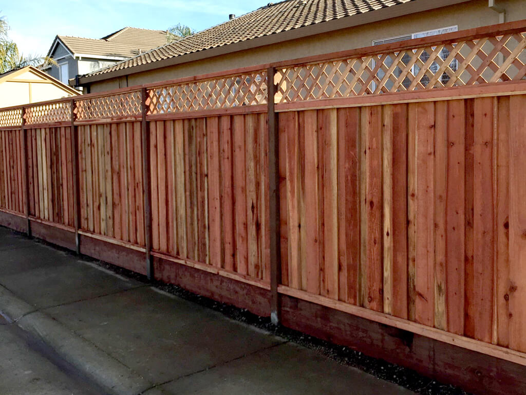 Cedar board-on-board privacy fence with kickboard in Oak Grove, MO — RKC Wood Care Pros