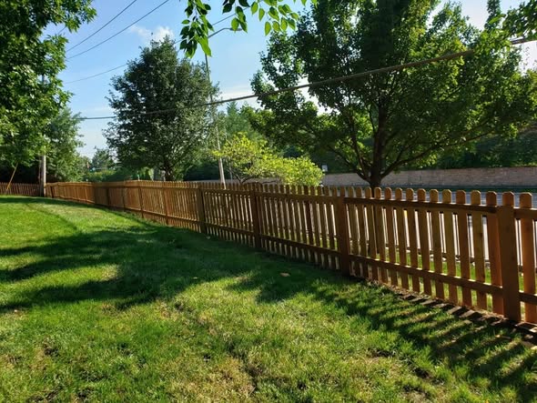 Cedar dog-ear picket privacy fence with galvanized ring-shank fastening in Grandview, MO — RKC Wood Care Pros
