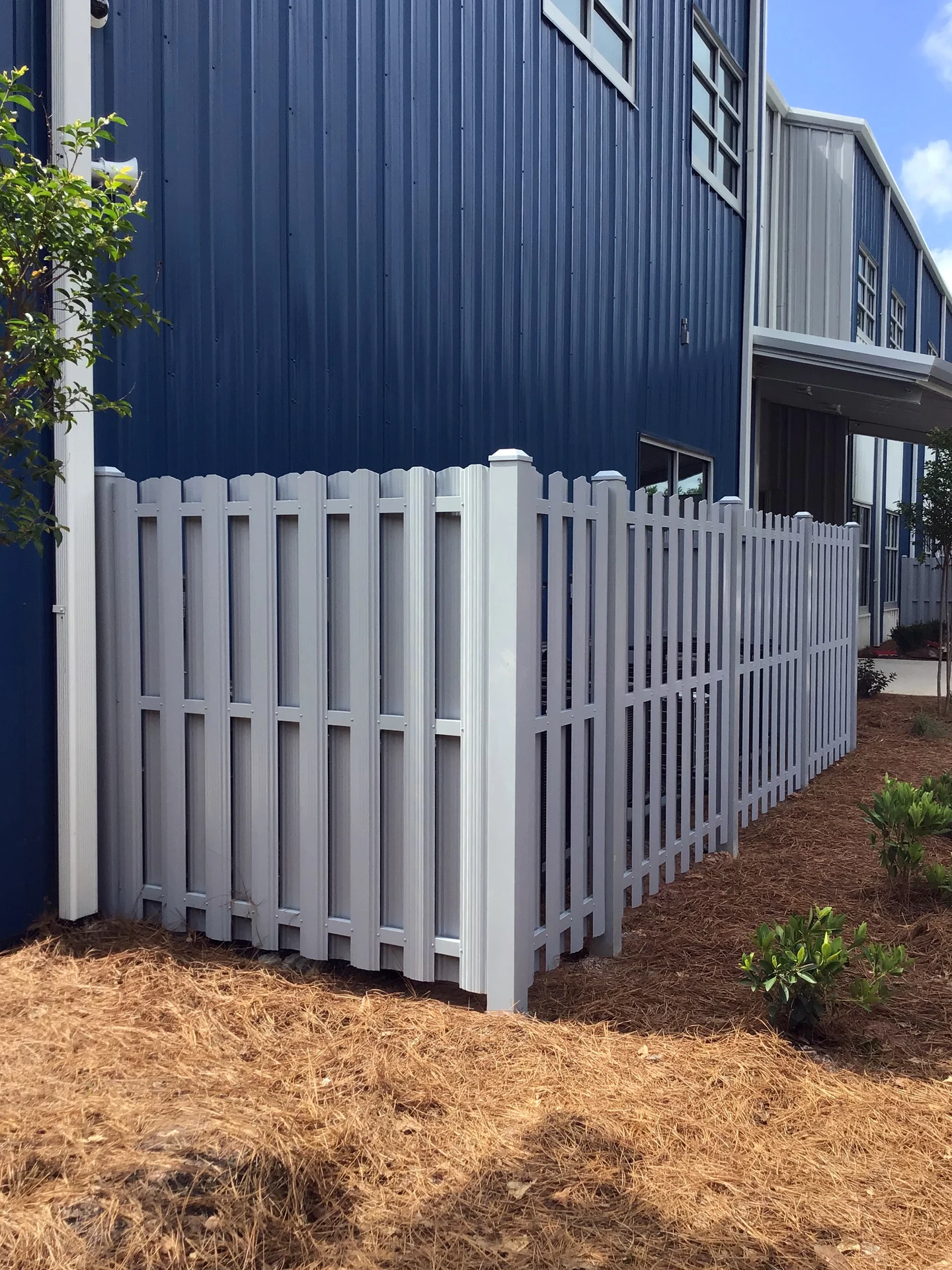 Dumpster screening enclosure with property line demarcation in Leawood, KS — RKC Wood Care Pros