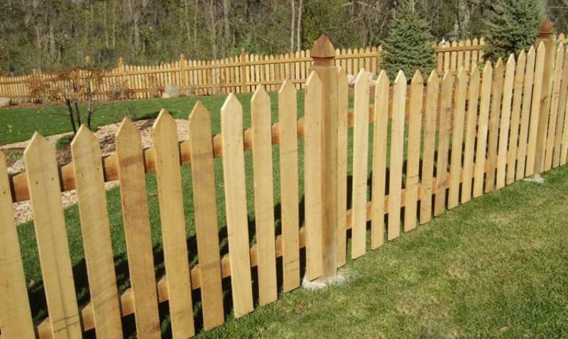 Cedar dog-ear picket privacy fence with galvanized ring-shank fastening in Pleasant Hill, MO — RKC Wood Care Pros