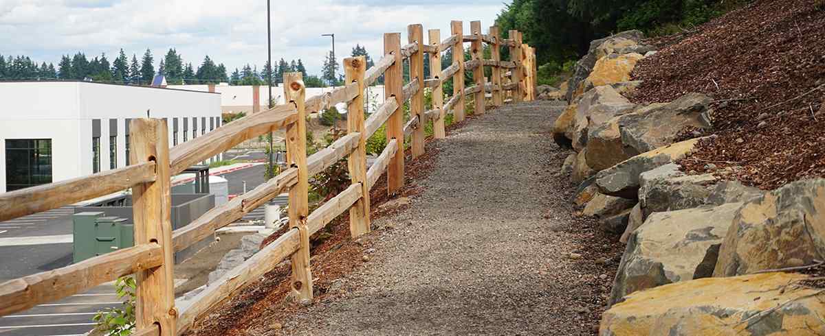 Western Red Cedar privacy fence set 36 inches deep in concrete in Raymore, MO — RKC Wood Care Pros