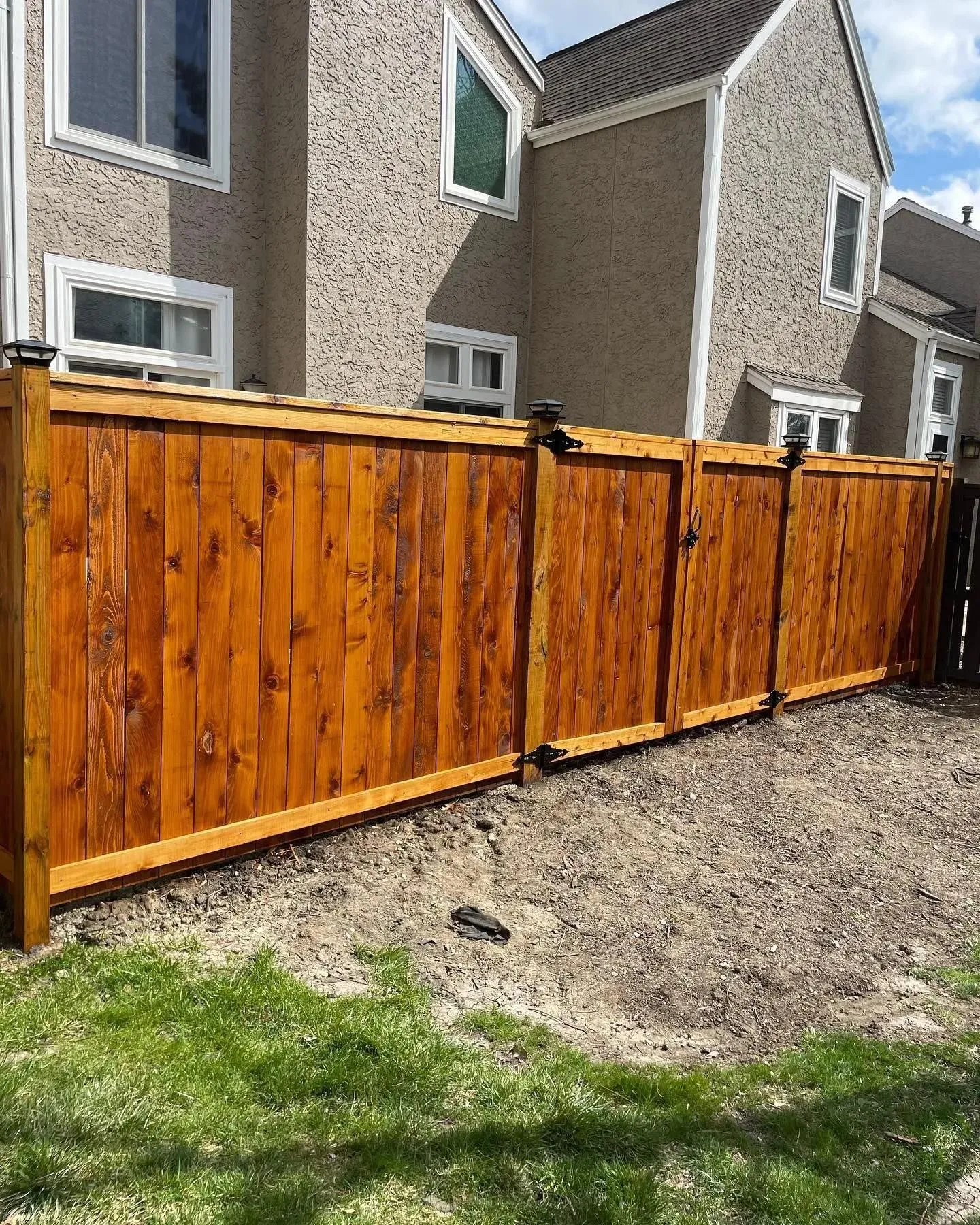 Wood fence with custom gate in Blue Springs MO by RKC Wood Care Pros