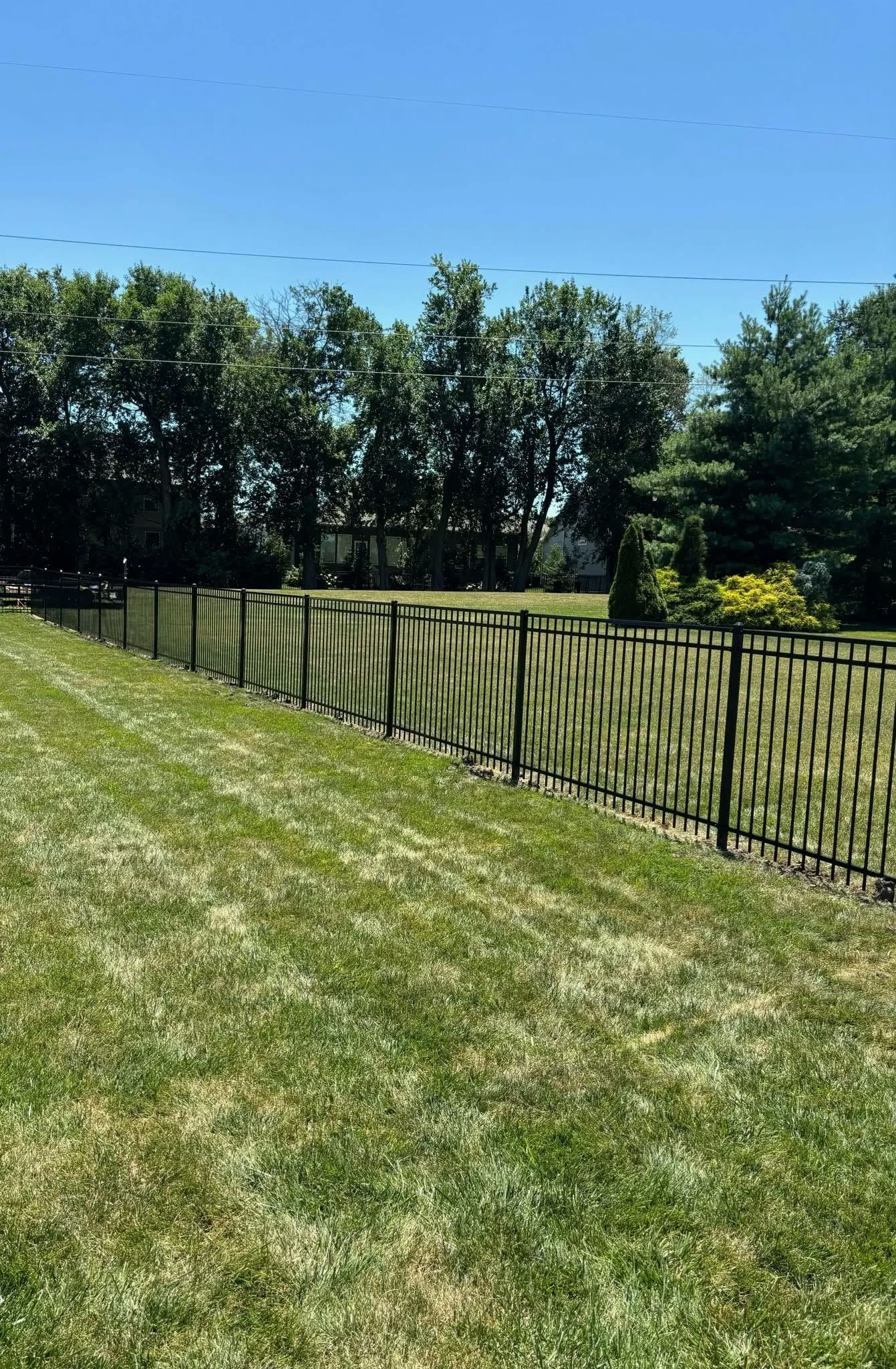Black aluminum fence installation in Kansas City by RKC Wood Care Pros