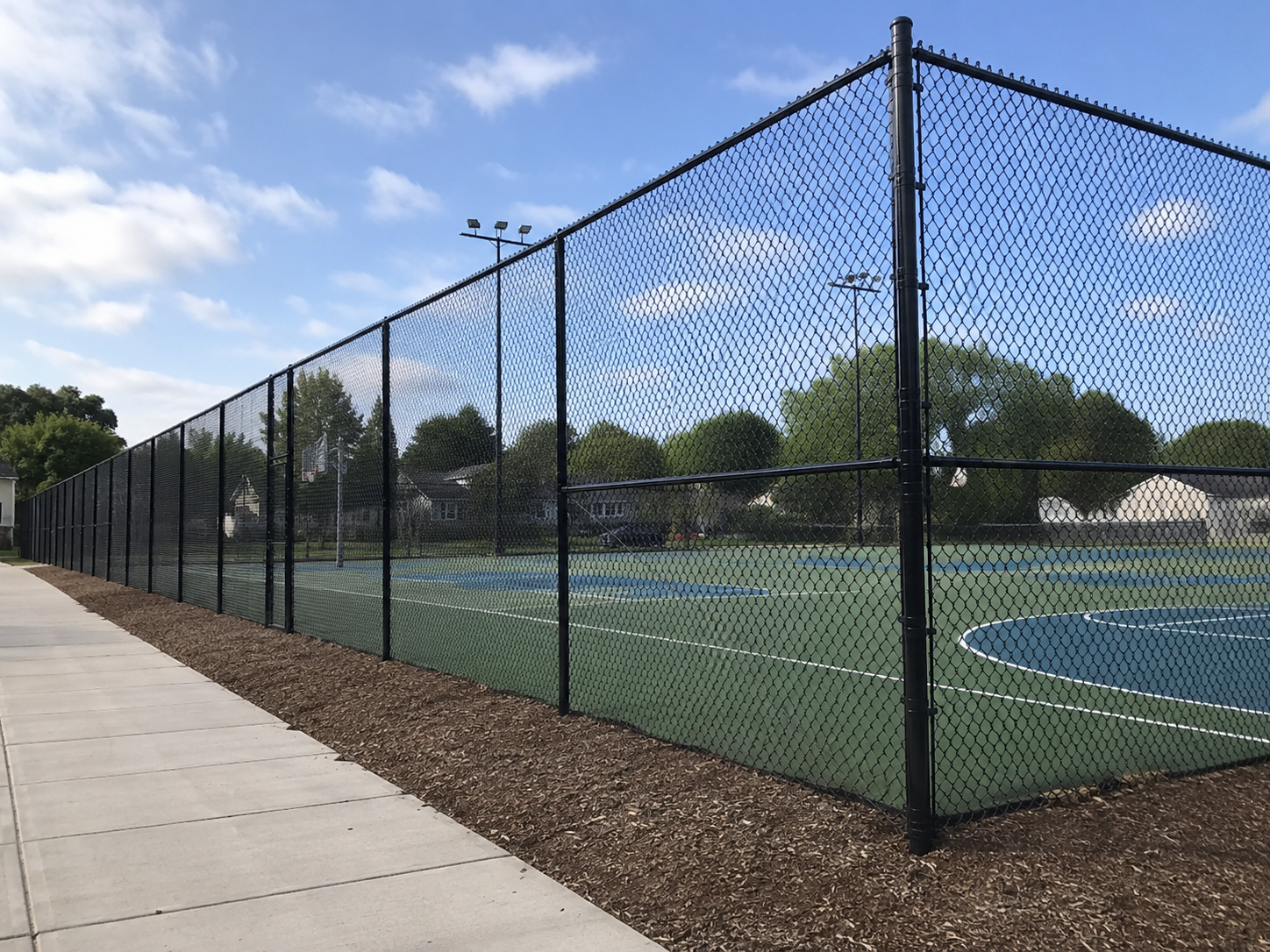 Commercial privacy slat fence at storage facility in Lee's Summit, MO by RKC Wood Care Pros