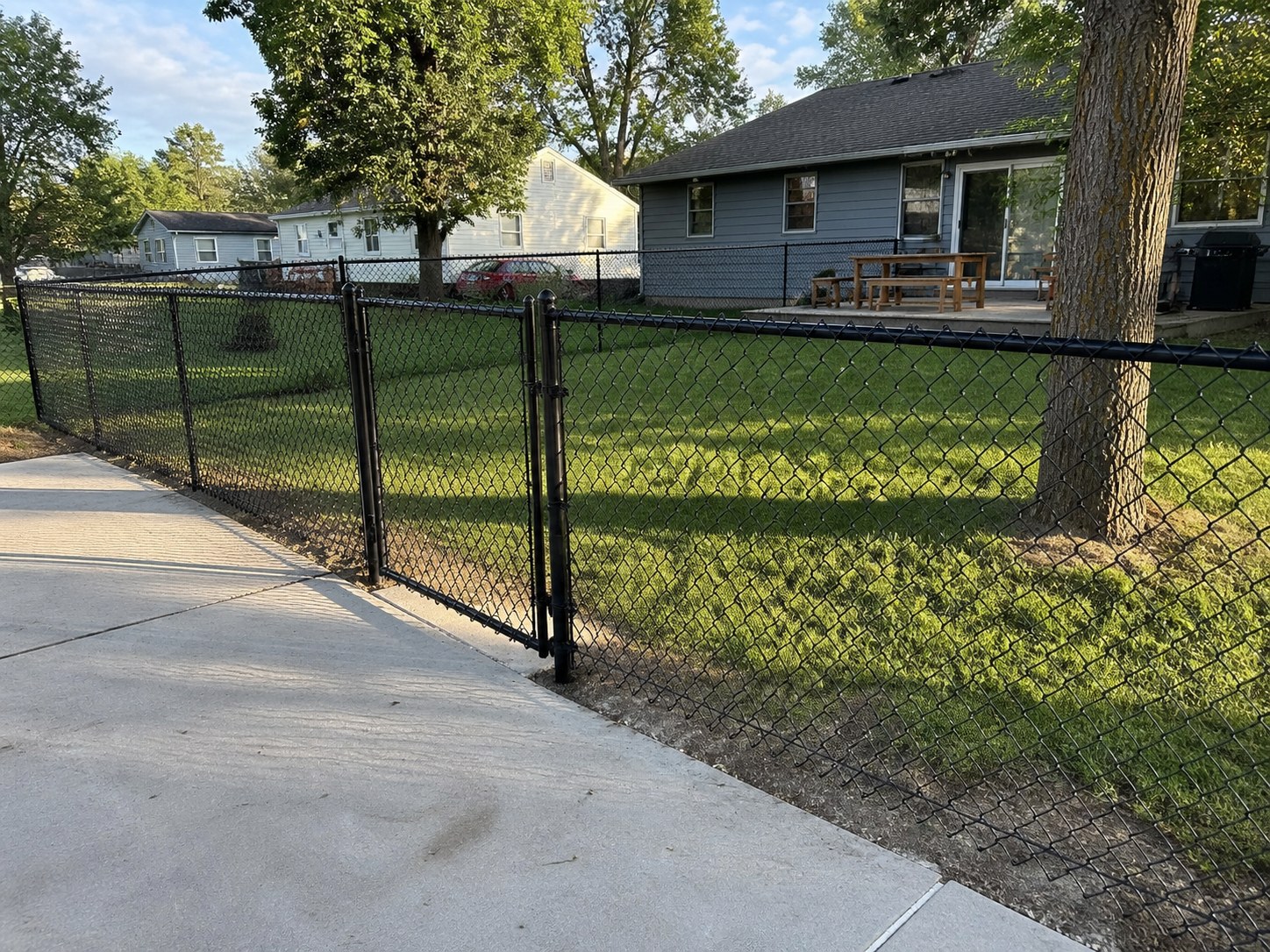 Galvanized chain link perimeter fence with knuckle-twist selvage in Liberty, MO — RKC Wood Care Pros