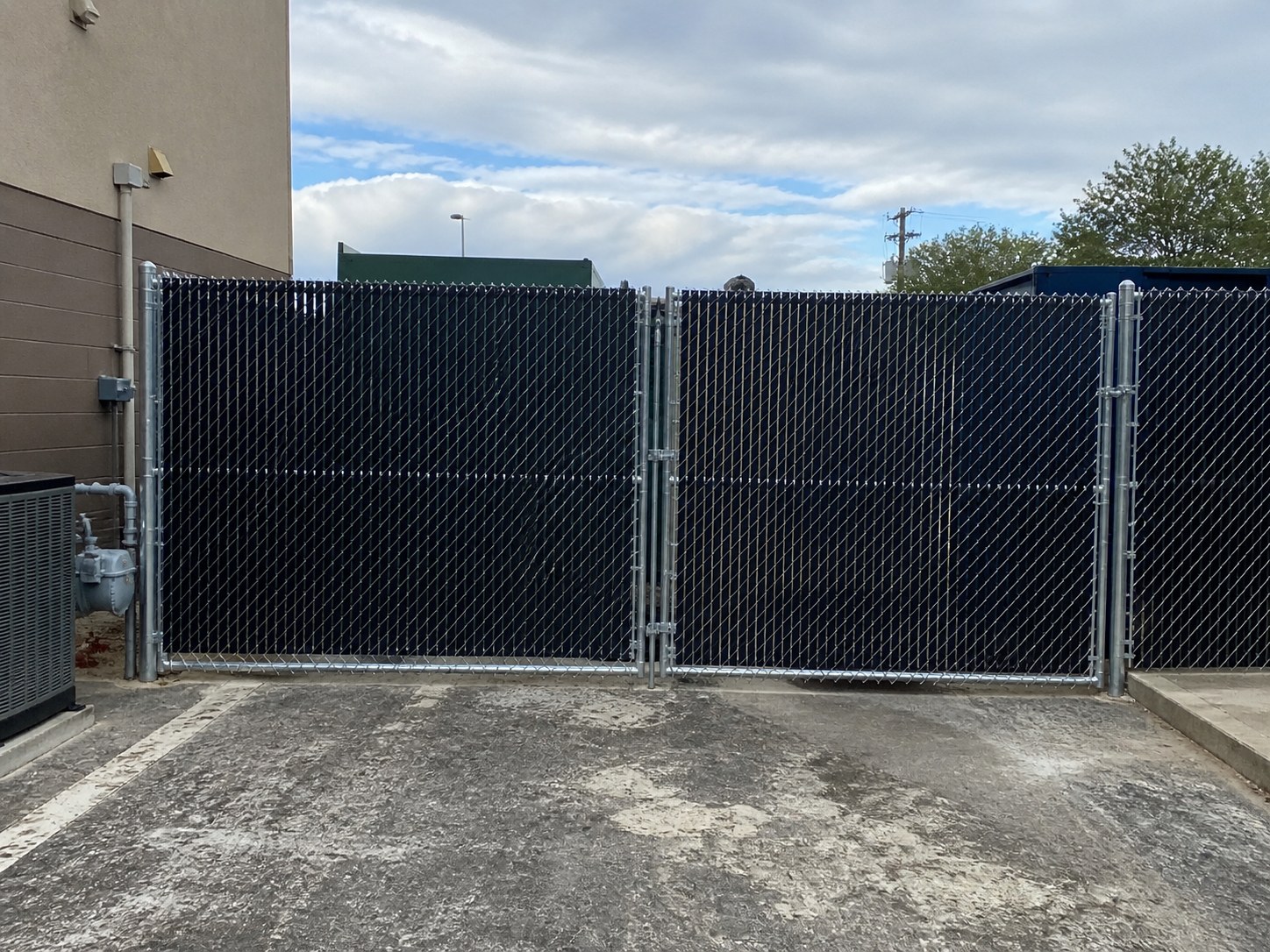 Black vinyl-coated chain link fence — Liberty, MO installation FAQ — RKC Wood Care Pros