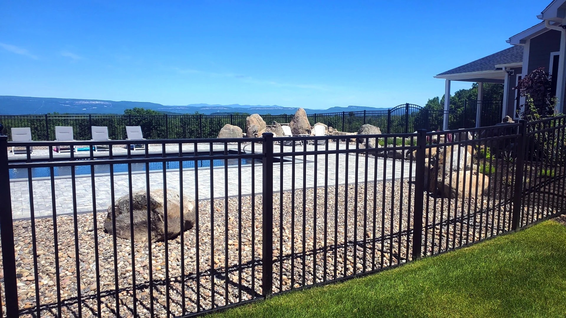 Ornamental iron fence on hilltop Palisades lot in Bonner Springs