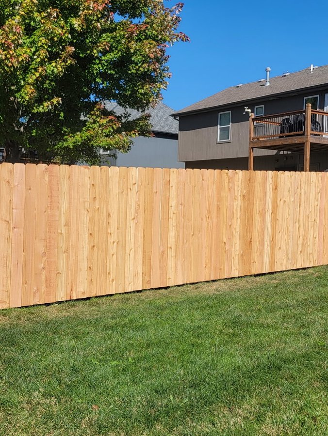 Cedar dog-ear picket privacy fence with galvanized ring-shank fastening in Smithville, MO — RKC Wood Care Pros