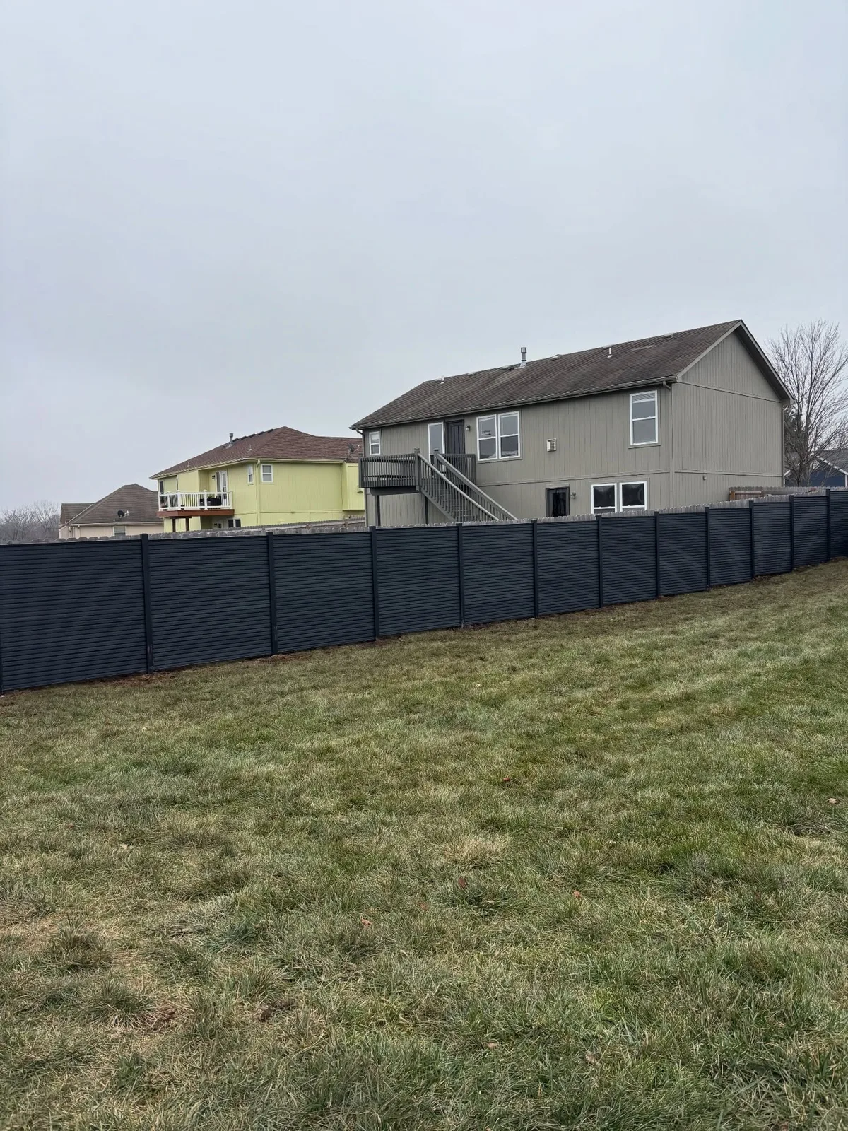Charcoal fence from inside yard angle in Belton, MO — clean horizontal lines