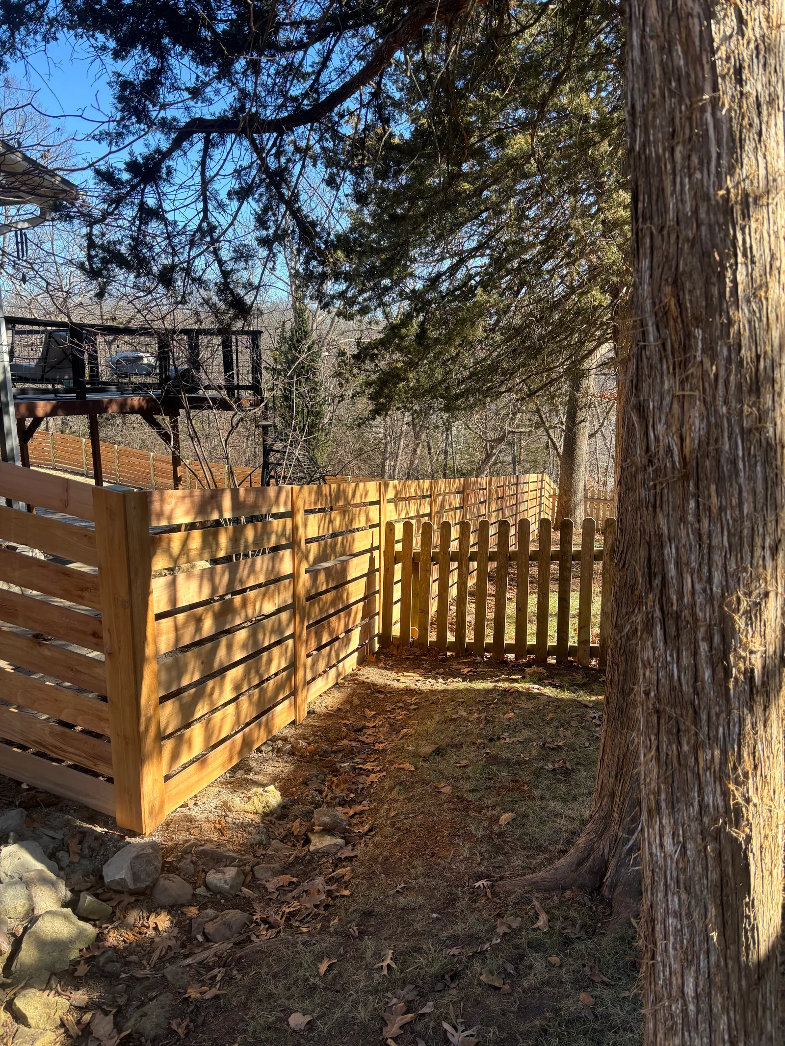New horizontal cedar slat fence installed in Prairie Village, KS — winter install, fresh boards